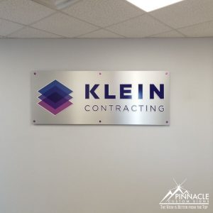 Brushed aluminum sign with acrylic and vinyl lettering